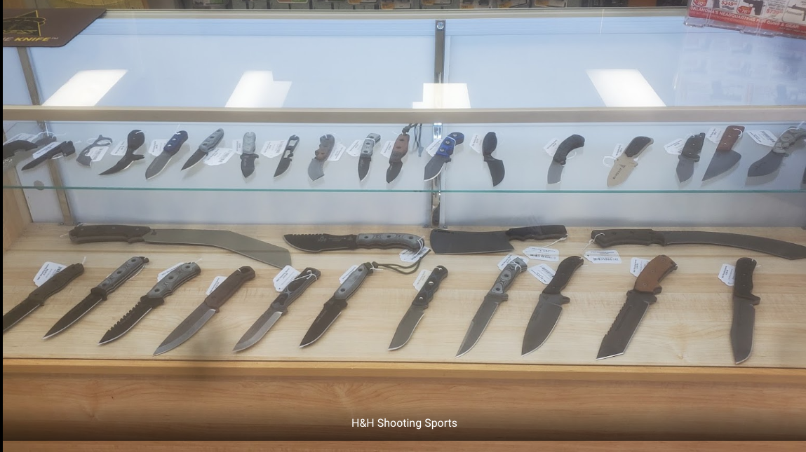 Different types of knives are kept inside a glass shelf at H&H Shooting Sports in Oklahoma City